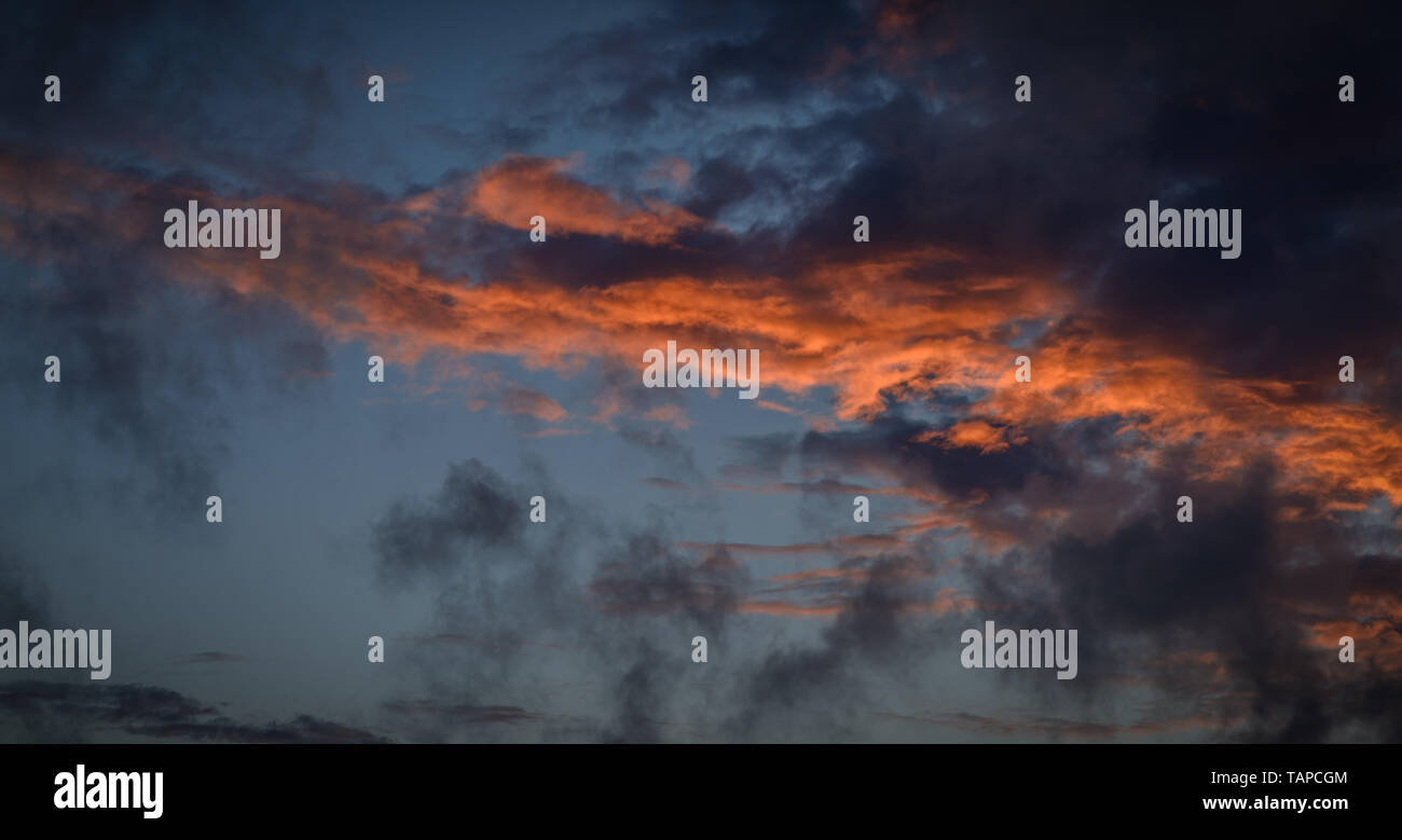 Dramatic sunset sky with orange colored clouds Stock Photo - Alamy