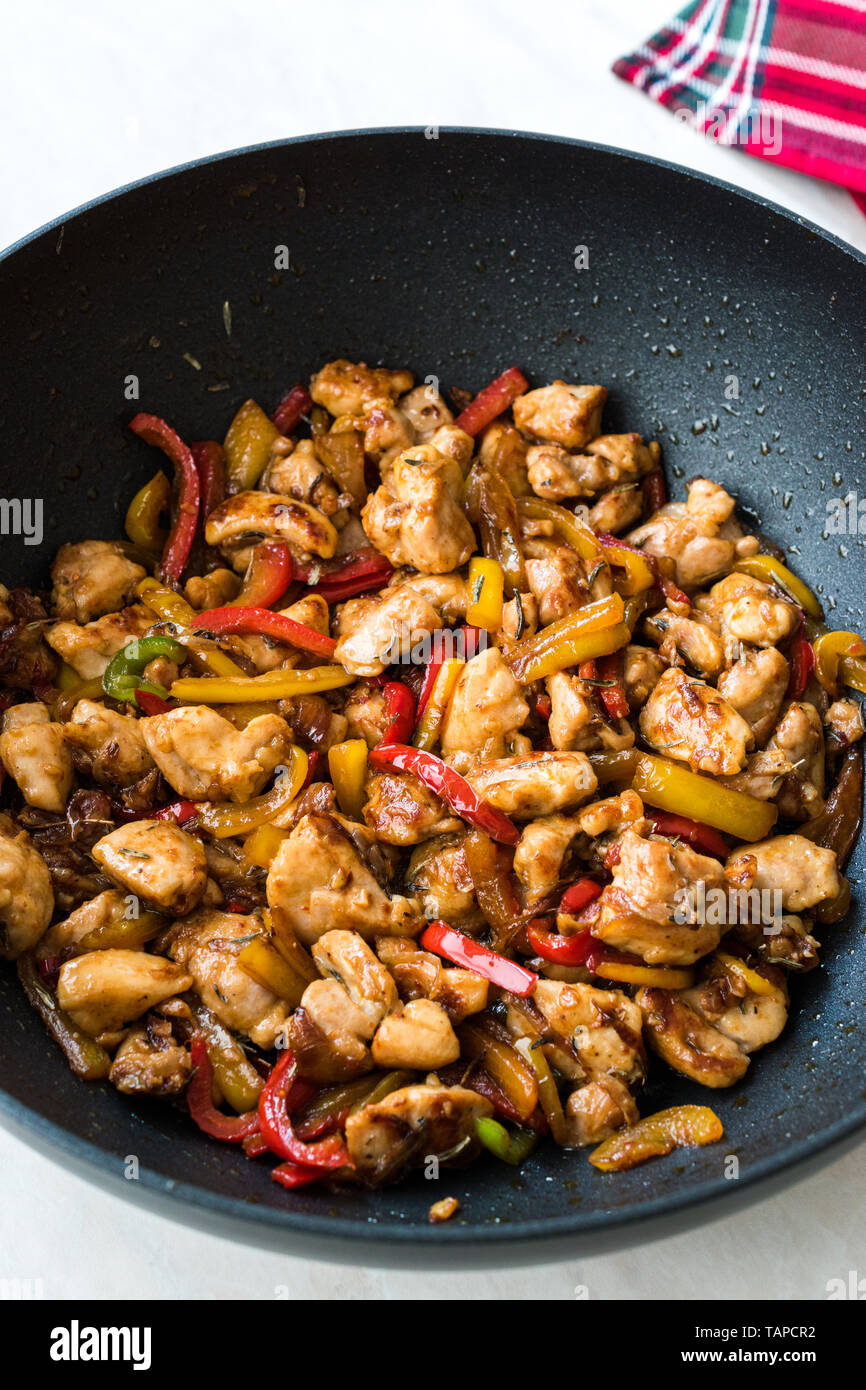 Manchurian Chicken with Soy Sauce, Julienne Vegetables in Iron Wok Pan