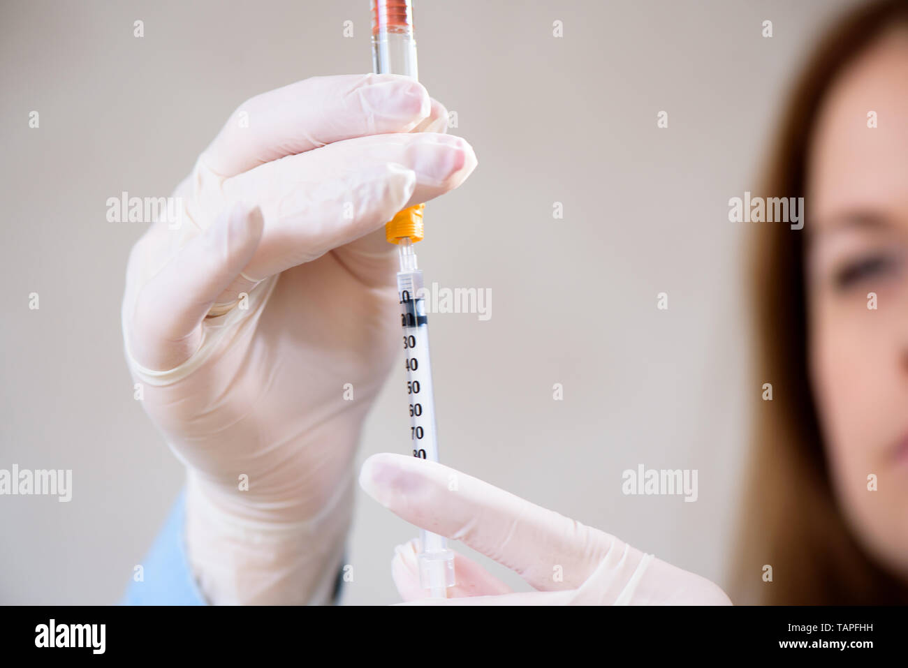 A girl fills a syringe for insulin injections. Diabetes. The short