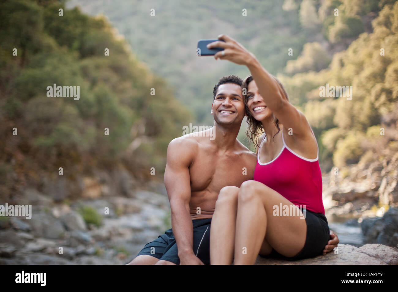 Smiling young couple posing for a self portrait. Stock Photo