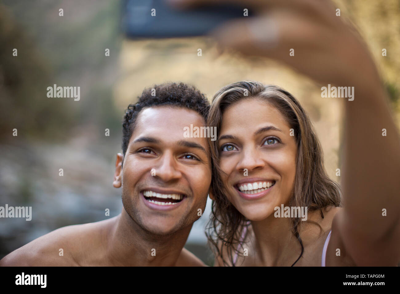 Smiling young couple posing for a self portrait. Stock Photo
