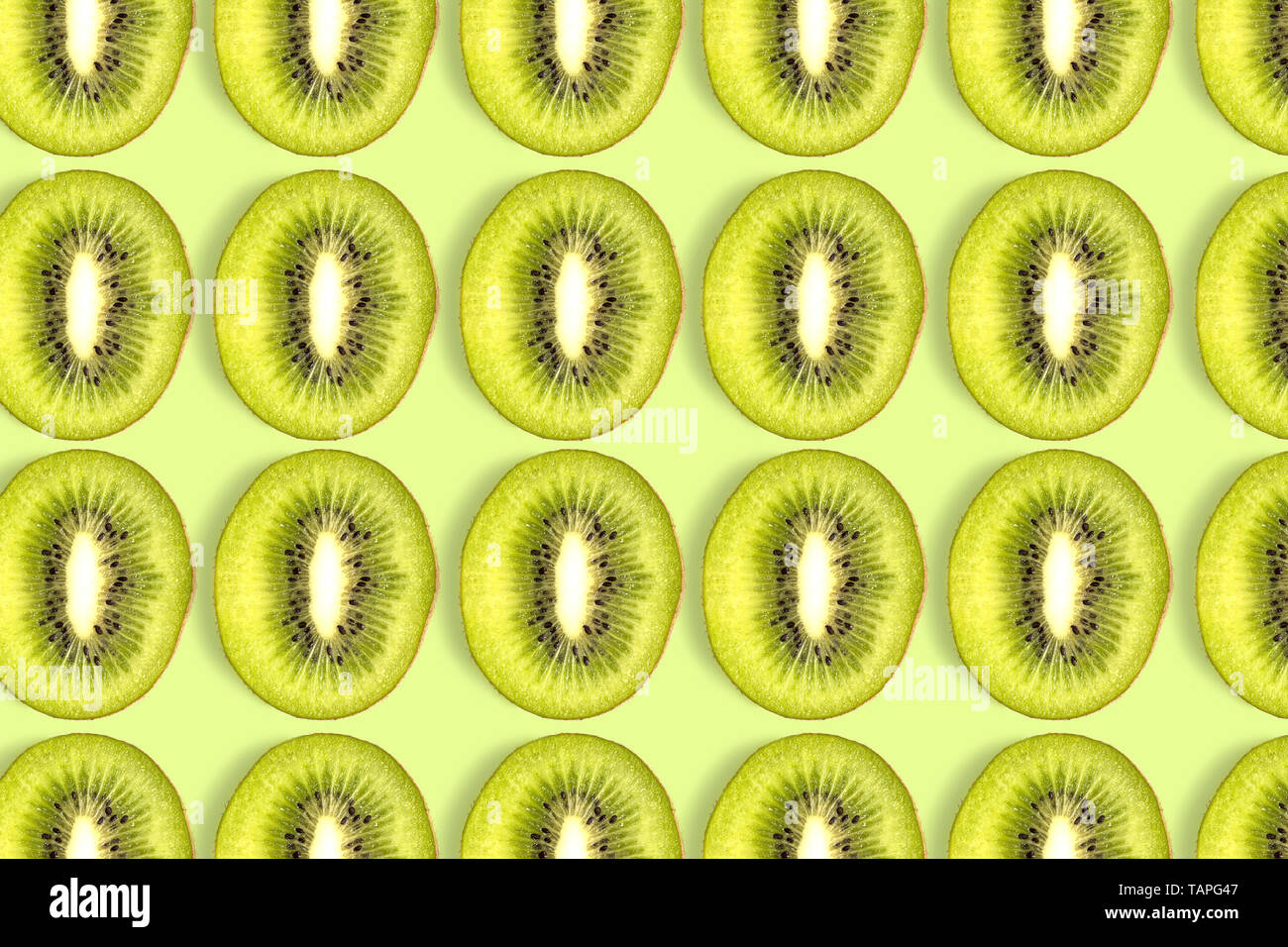 kiwi fruit sliced pattern on green background Stock Photo