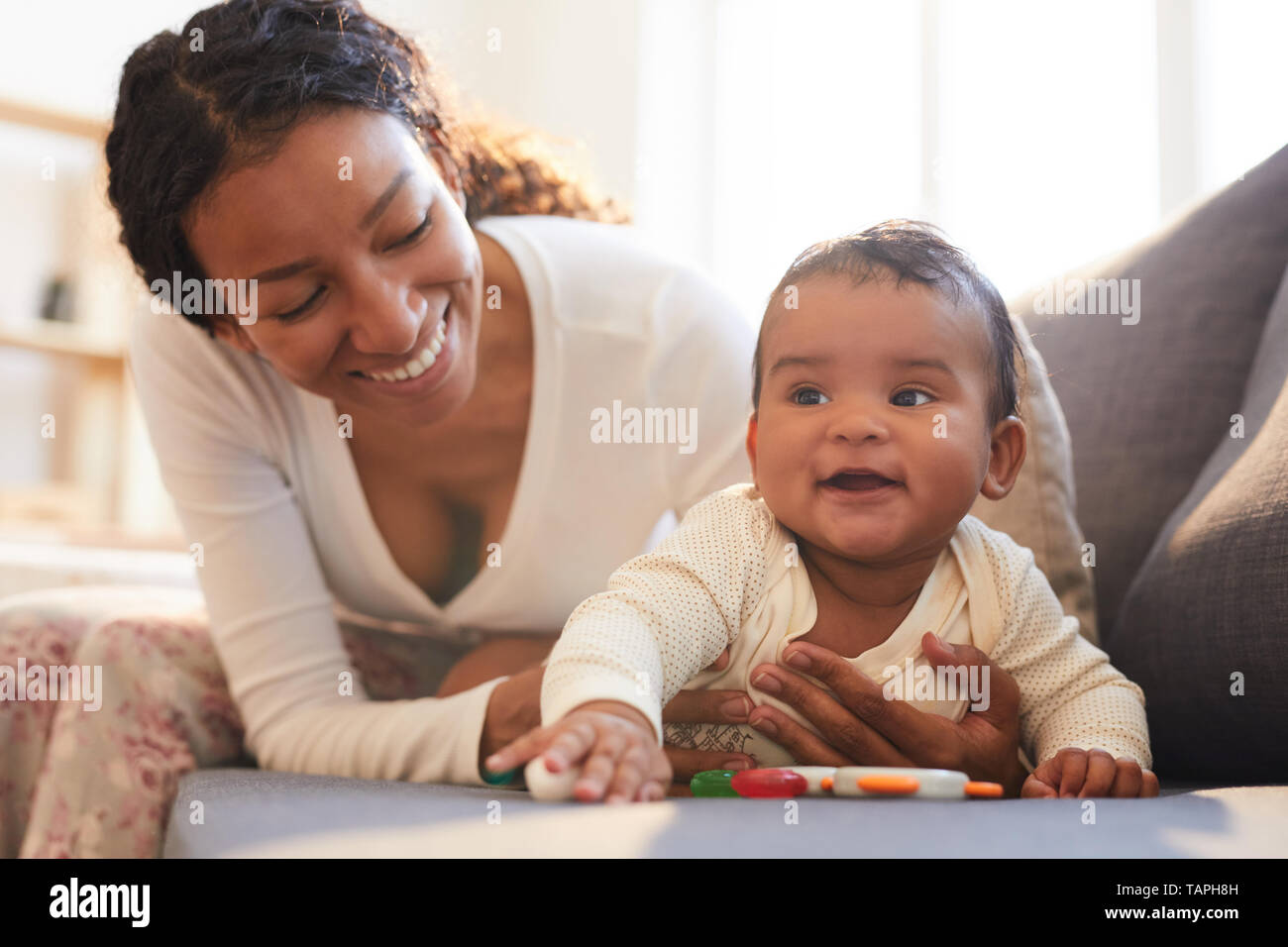 Positive loving young black mother spending beautiful time with her