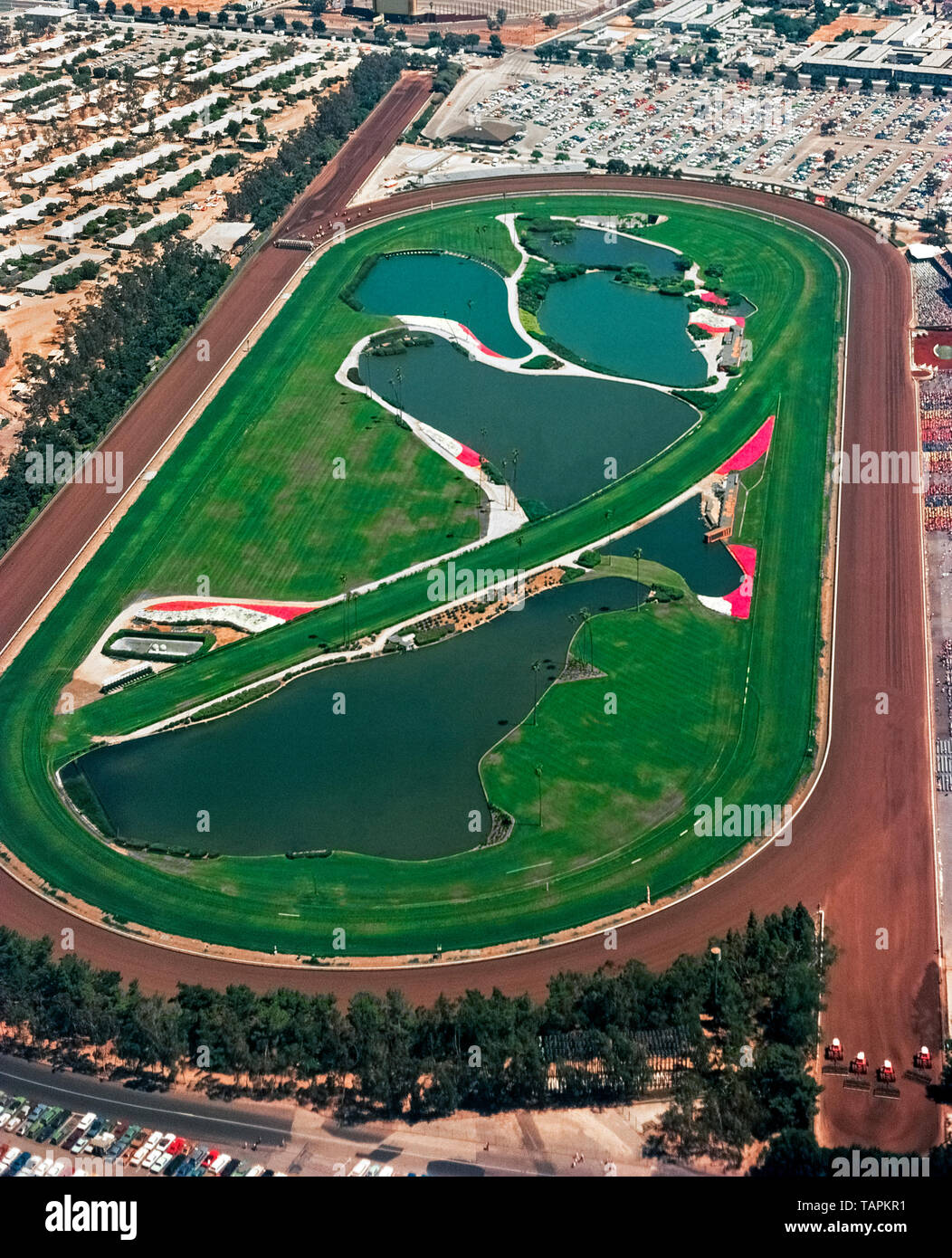 This historical 1974 aerial photograph shows the now-demolished Hollywood Park Racetrack that was famous for 75 years as the place for thoroughbred horse racing in Los Angeles County, California, USA. The track opened in Inglewood in 1938 and closed at the end of the 2013 race season. The 298-acre (121-hectare) site is being transformed into a residential, entertainment and sports center that features the new 70,000-seat Los Angeles Stadium. Home games of two National Football League (NFL) teams, Los Angeles Chargers and Los Angeles Rams, will be played there, as will the Super Bowl in 2022. Stock Photo