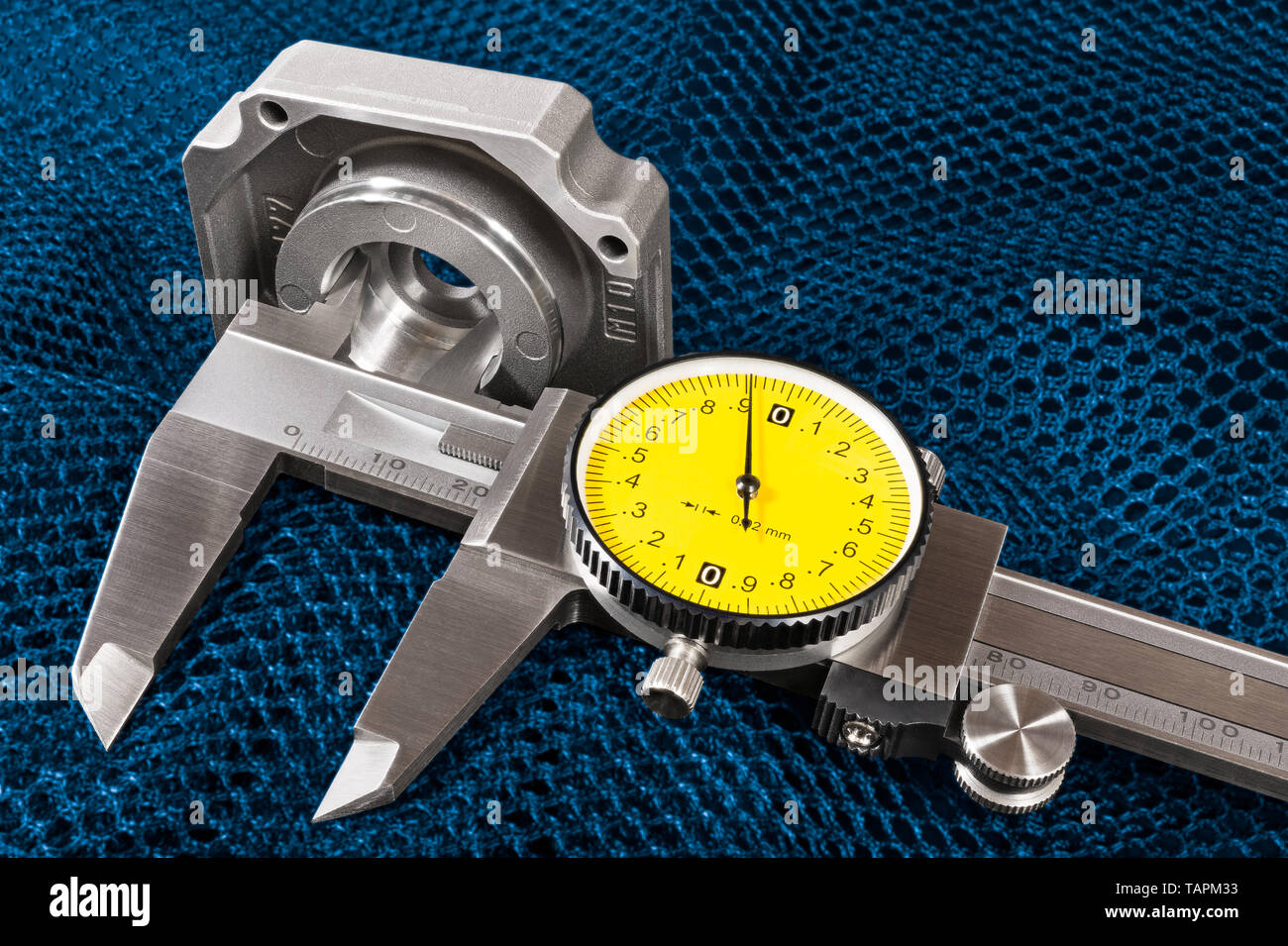 Caliper jaws closeup. Internal hole diameter measuring on a blue net