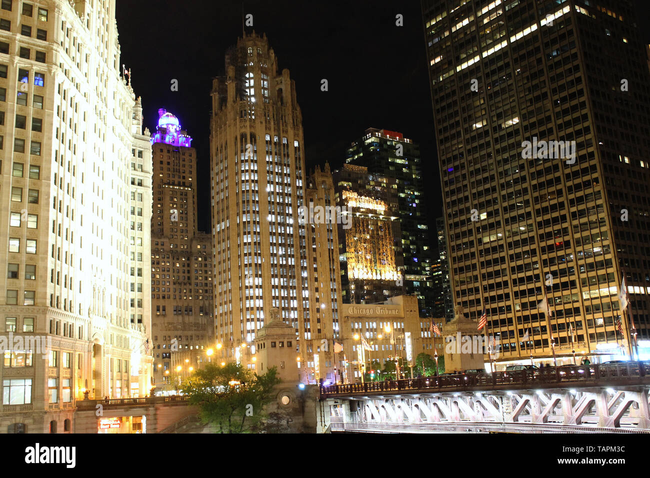 The Wrigley Building, Tribune Tower, and 401 N Michigan Ave along the Chicago River in downtown Chicago, Illinois at night Stock Photo
