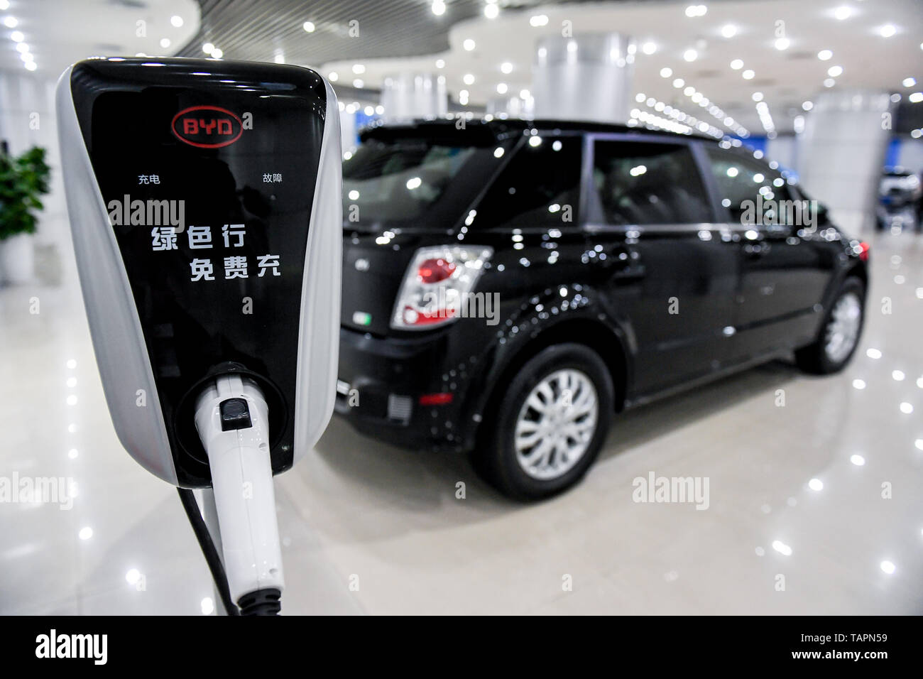 Beijing, China. 30th Nov, 2018. Photo taken on Nov. 30, 2018 shows a charging device and a new energy vehicle at the headquarters of China's new energy vehicle maker BYD in Shenzhen, south China's Guangdong Province. Recent financial reports released by many markets indicate that the increase in R&D investment has boosted enterprises' performances. Credit: Mao Siqian/Xinhua/Alamy Live News Stock Photo