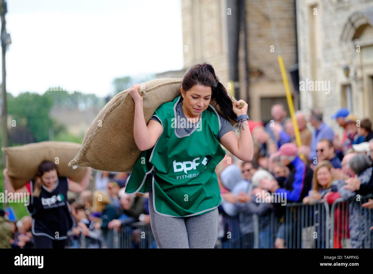 Tetbury, Gloucestershire, UK. 27th May, 2019. The annual races attract large crowds and raise money for local charities. Competitors race up steep Gumstool Hill in this pretty Cotswold town carrying a woolsack. The men carry a 60lb sack and the ladies a 30lb sack. Credit: Mr Standfast/Alamy Live News Stock Photo