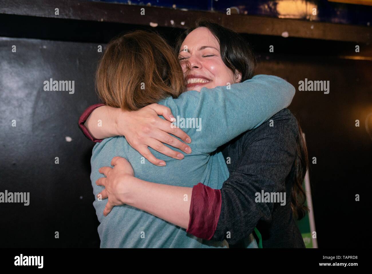 Birmingham, UK. 27th May, 2019. Green Party deputy leader Amelia Womack (left) hugs new West Midlands MEP Ellie Chowns (right) at an event to celebrate the results of the EU election that saw Greens rise from three to seven seats in England. Credit: Vladimir Morozov/Alamy Live News Stock Photo