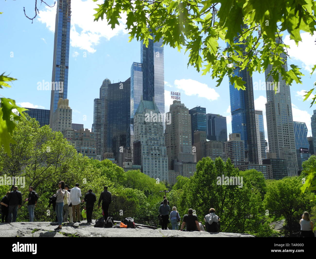 New York, USA. 15th May, 2019. People in Central Park are looking at huge skyscrapers. New skyscrapers are springing up in New York. Some use loopholes to offer their wealthy customers a fantastic view. But there is resistance. (to dpa "million penthouses in 400 meters height: Who owns New York's skyline?" from 27.05.2019) Credit: Benno Schwinghammer/dpa/Alamy Live News Stock Photo