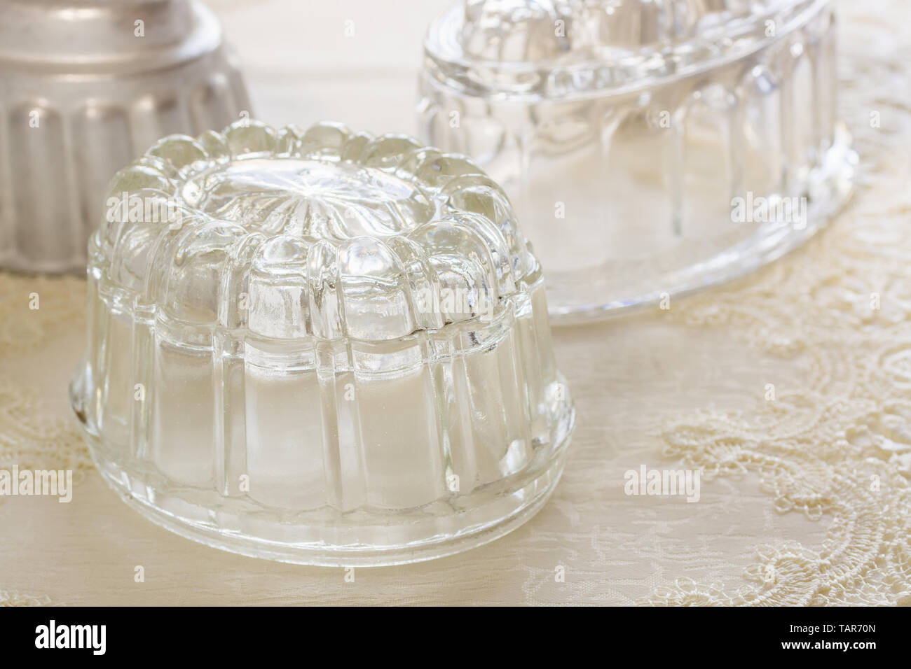 Old fashioned glass jelly or blancmange moulds for making traditional jellies Stock Photo