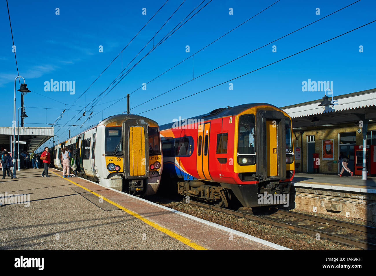Morning commuter passenger trains passing at Ely station Stock Photo