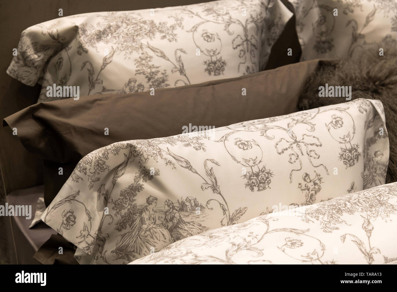 Beautiful Beige different pillows on bed, bedroom fragment Stock Photo