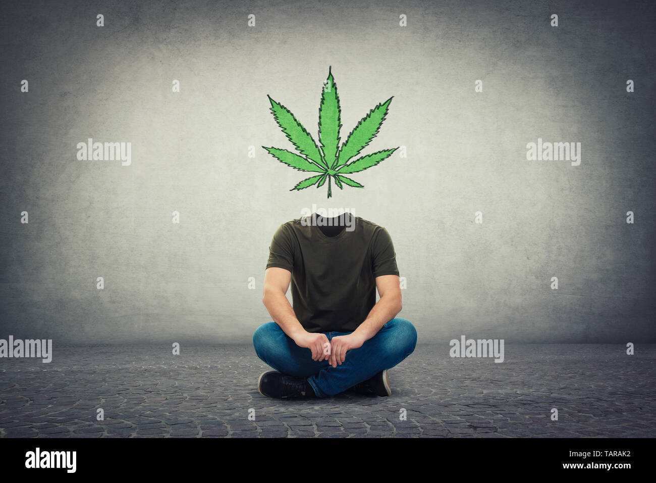 Surreal headless guy, invisible face seated on the floor with marijuana leaf symbol instead of head, as brain cure. Cannabis legalization as medical d Stock Photo