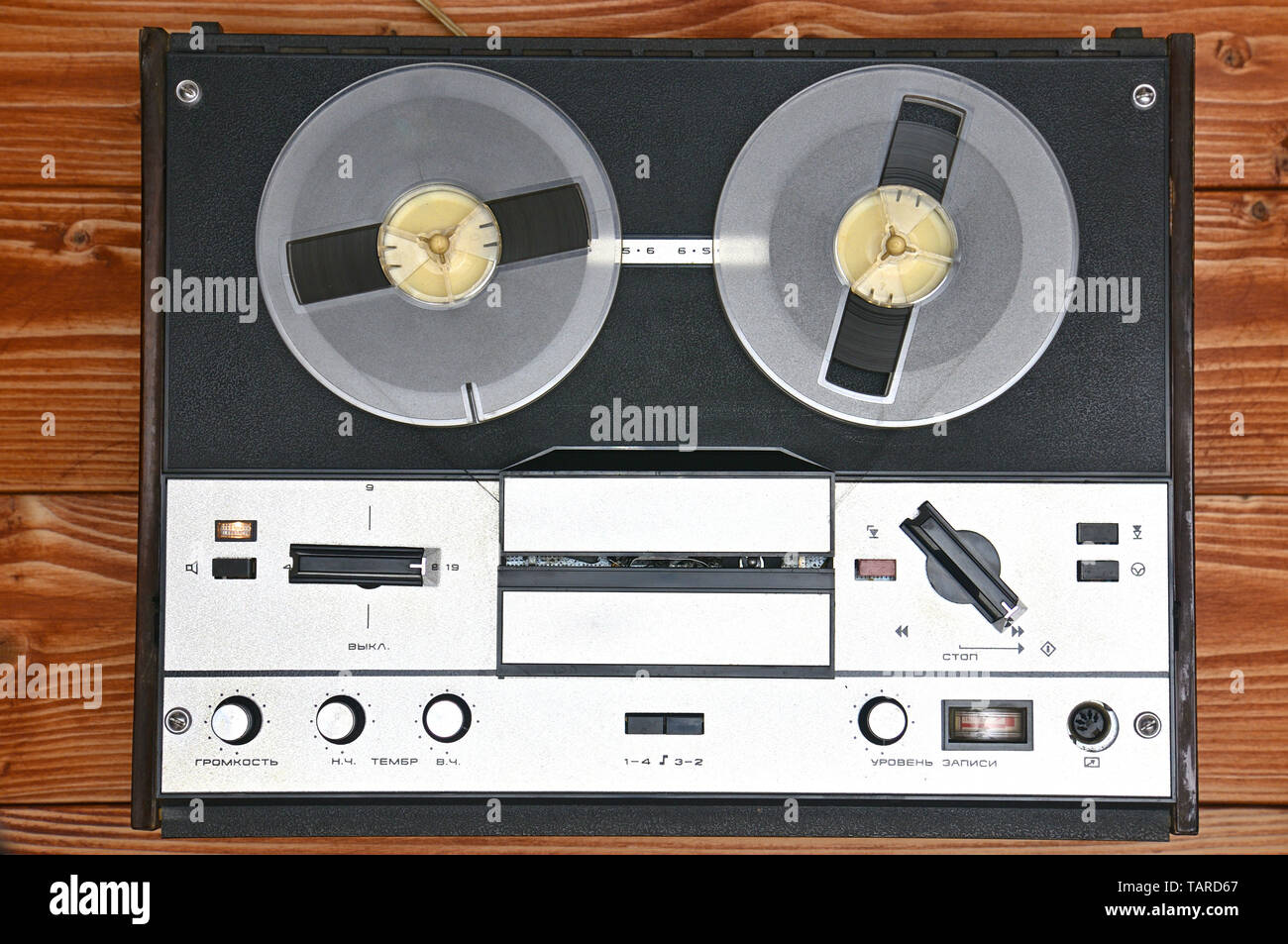 Vintage reel to reel tape recorder on a brown wooden background. Retro tape  recorder from the Soviet Union Stock Photo - Alamy