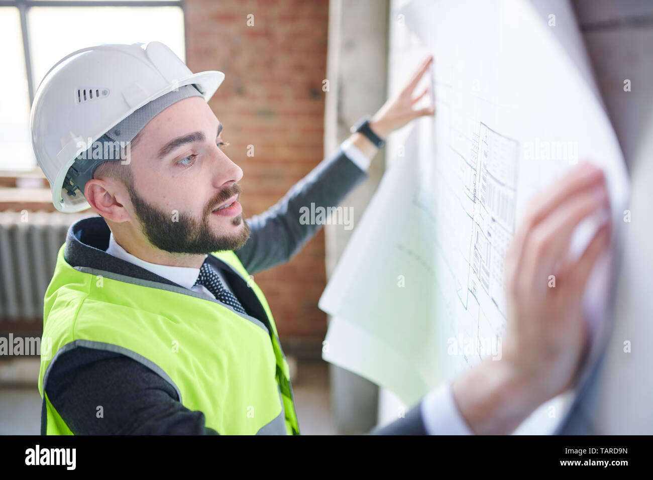 Foreman checking blueprint paper hi-res stock photography and images ...