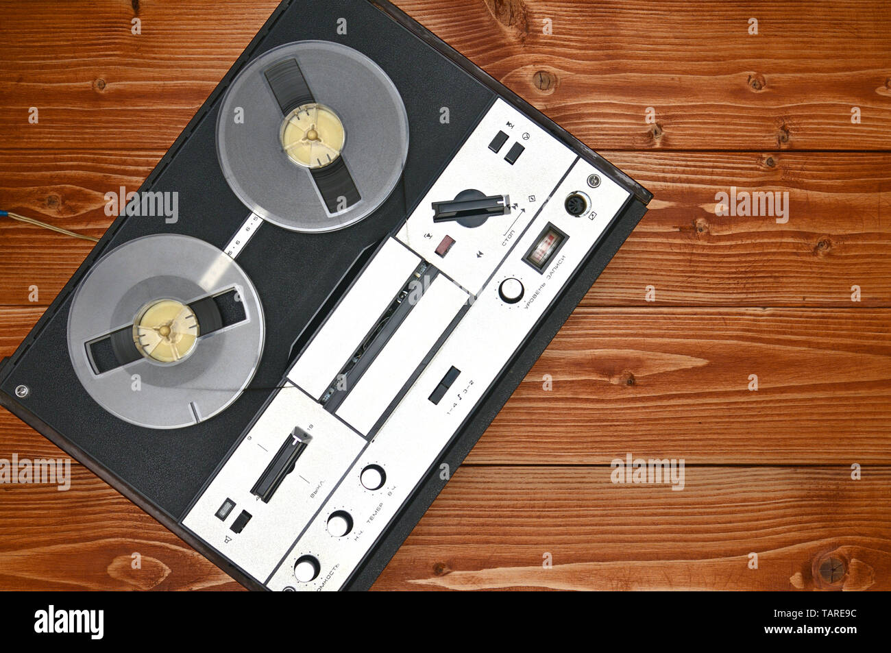Vintage reel to reel tape recorder on a brown wooden background. Retro tape  recorder from the Soviet Union Stock Photo - Alamy