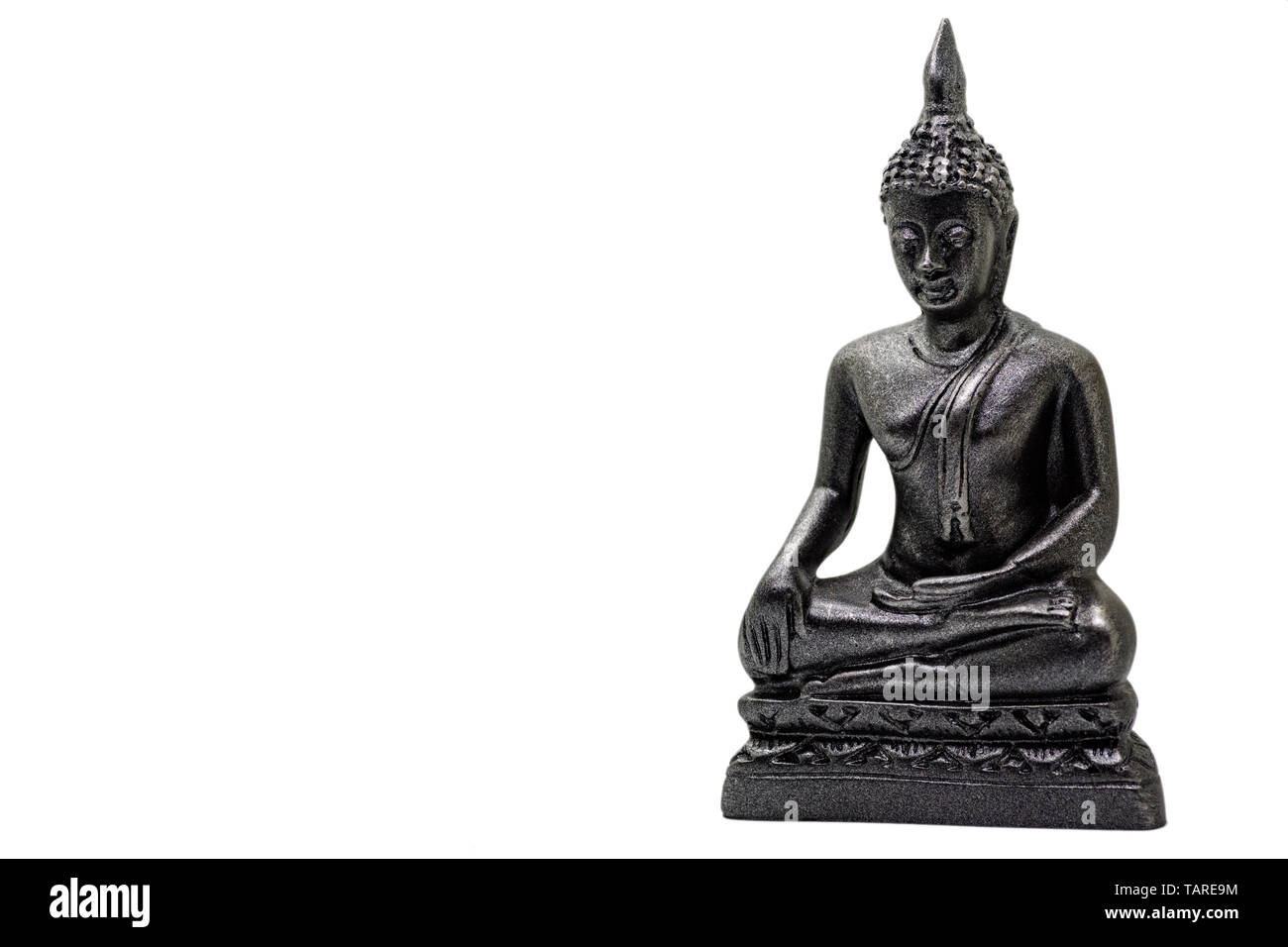 Photo of little buddha sitting from black stone isolated Stock Photo