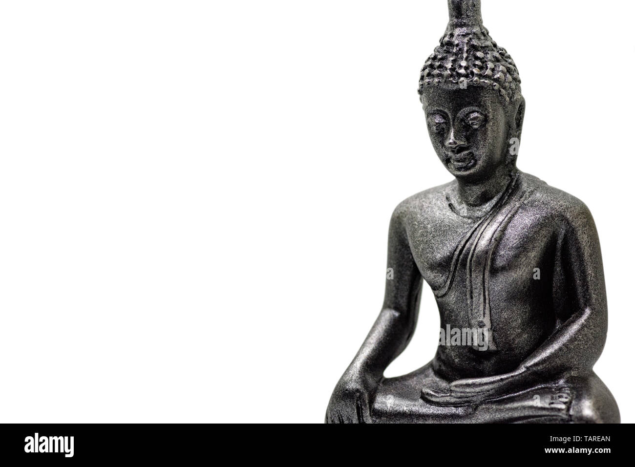 Photo of little buddha sitting from black stone isolated Stock Photo