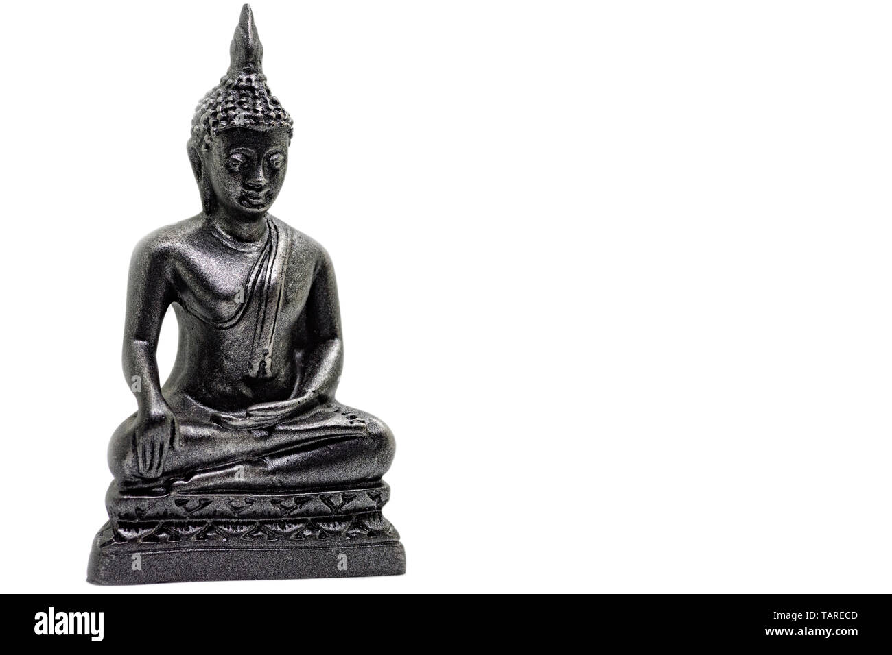 Photo of little buddha sitting from black stone isolated Stock Photo