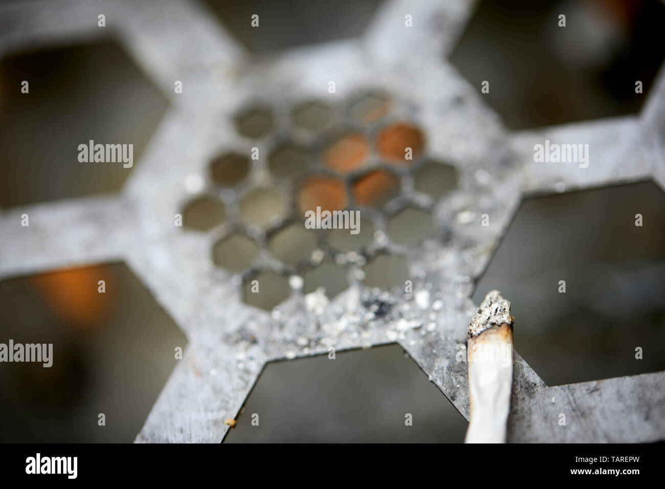 Manchester bee bin smoker stub it out honeycomb design Stock Photo