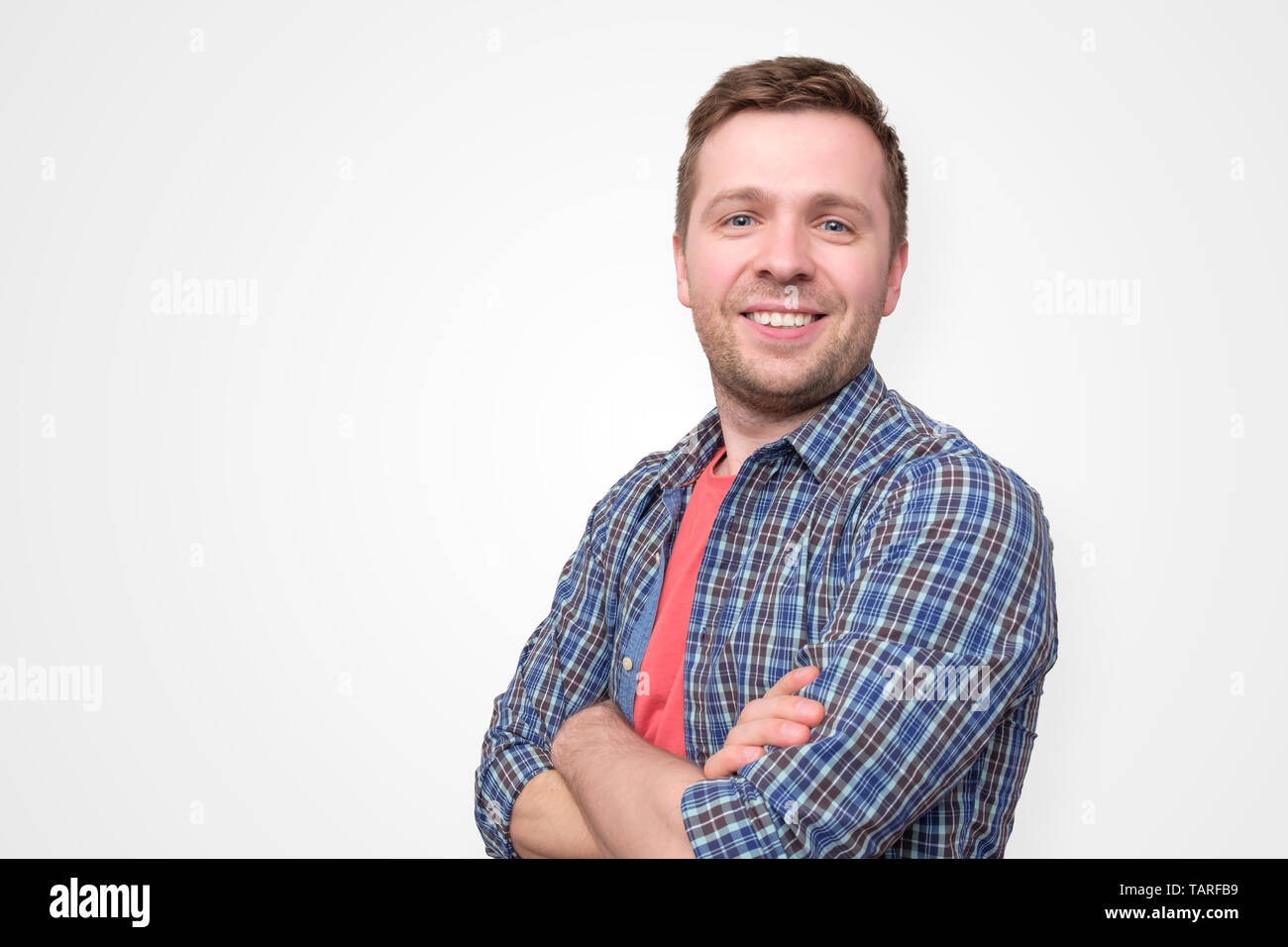 Confident young man standing isolated over white background Stock Photo ...
