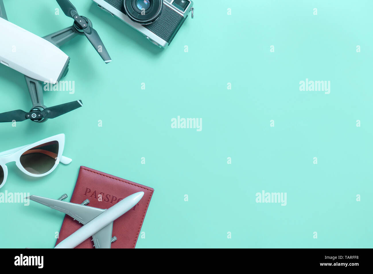 Travel gadgets flat lay on blue teal background for travel concept Stock Photo
