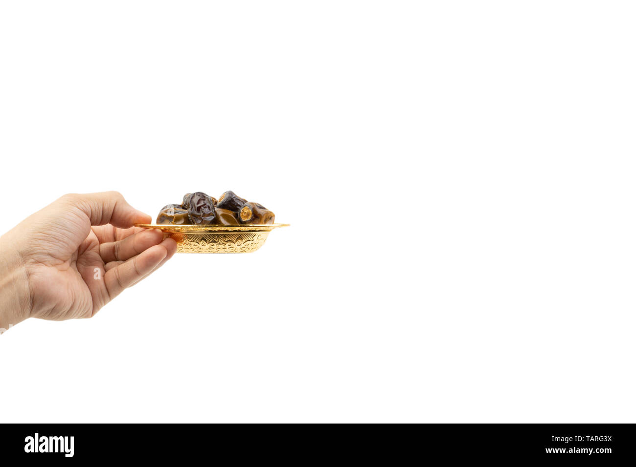 Hand holding dried dates fruits isolate on white. Selective focus Stock Photo