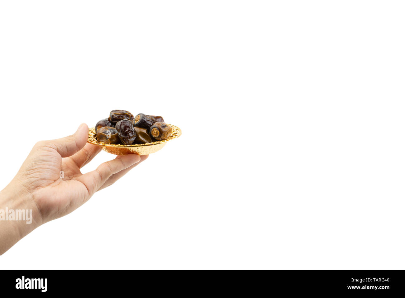 Hand holding dried dates fruits isolate on white. Selective focus Stock Photo
