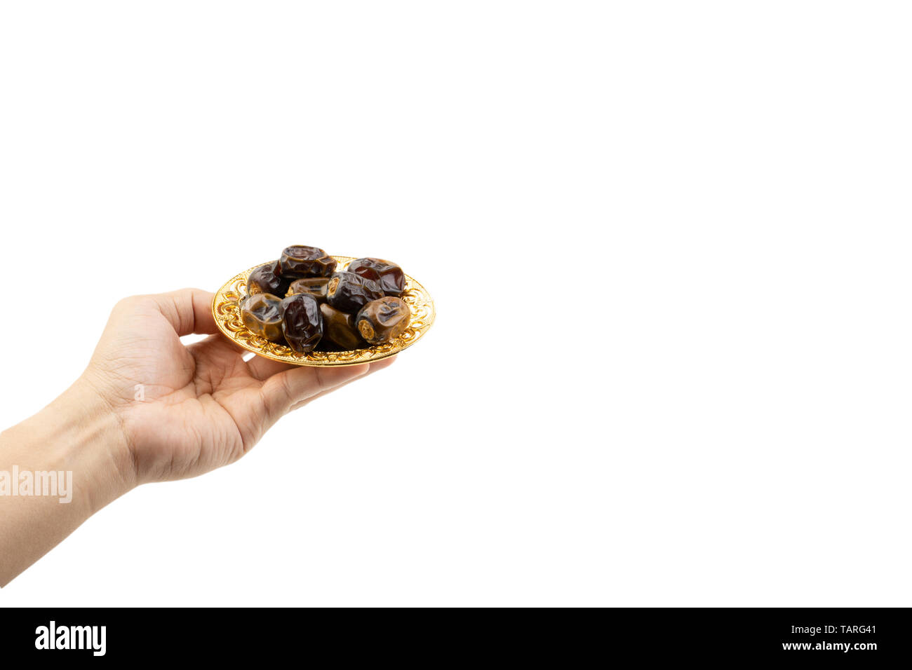Hand holding dried dates fruits isolate on white. Selective focus Stock Photo