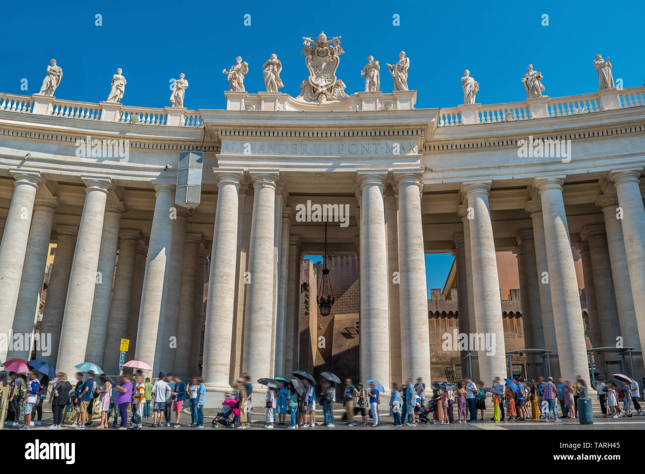 People and Doric Columns of St. Peter's Square in the Vatican Stock Photo
