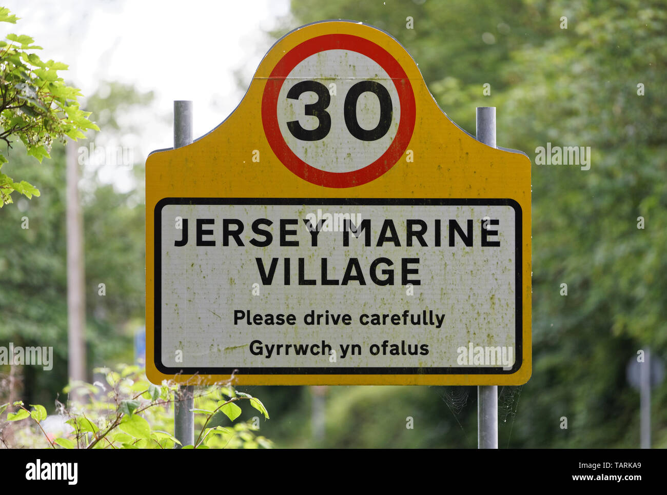 A village sign on the B4290 road, Jersey Marine in the county of Neath Port Talbot, Wales, UK. Friday 24 May 2019 Stock Photo