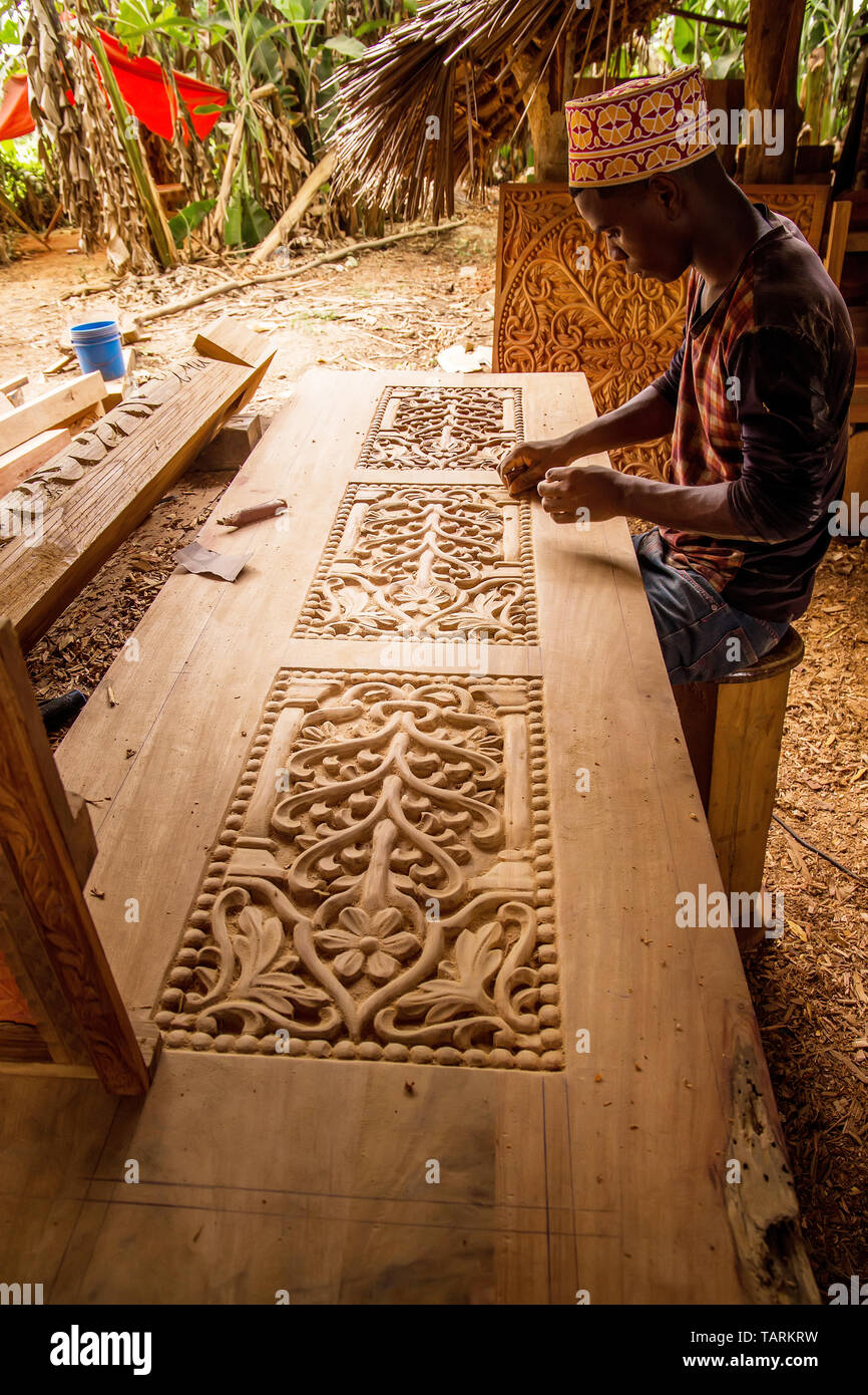 Zanzibar, Tanzania, March 29, 2018. one african man wood carve doing