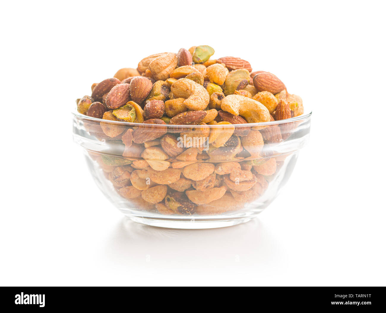 Spicy flavoured nuts. Mix of nuts in bowl isolated on white background. Stock Photo
