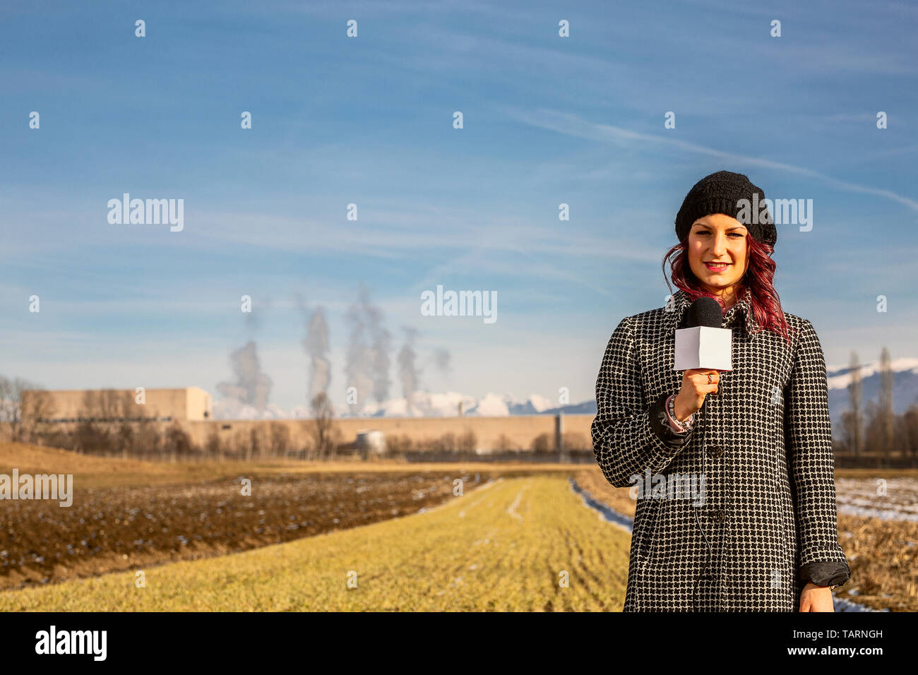 Professional reporter beautiful girl standing on the green with a ...