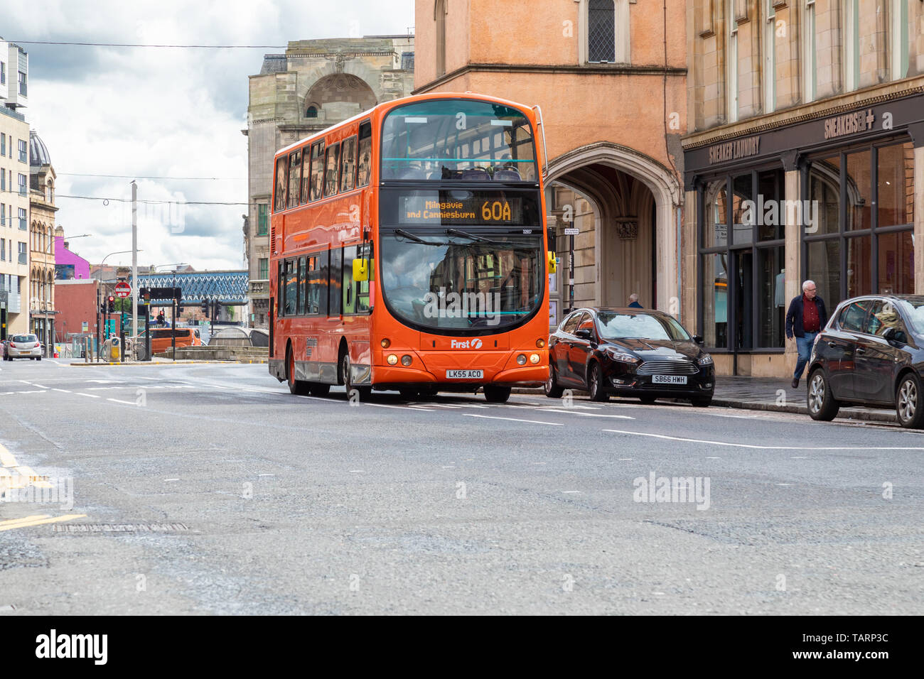 To celebrate 125 years of public transport in Glasgow First Bus have painted a Volvo B7TL bus in the retro 1980's Stratchclyde's Buses orange livery Stock Photo