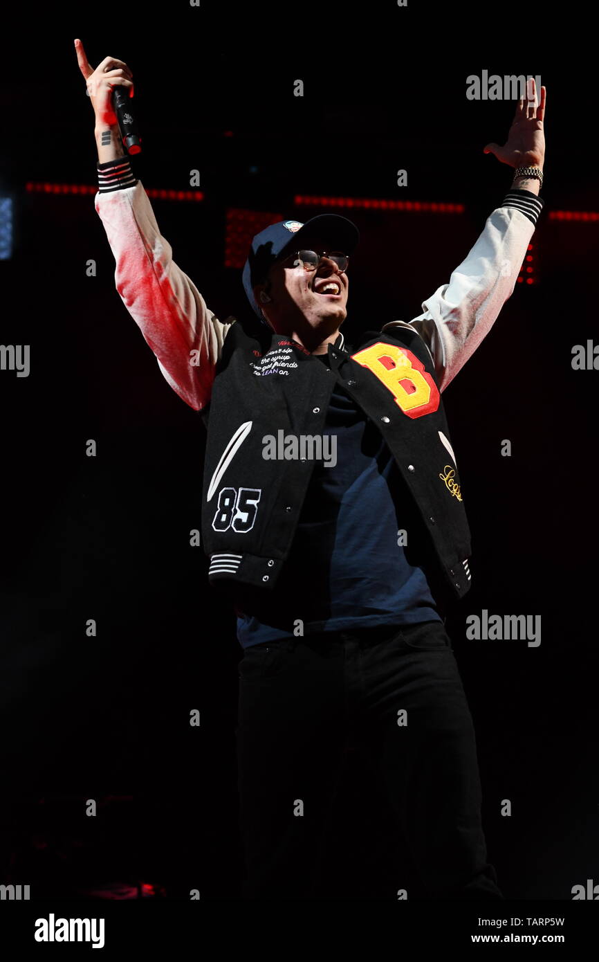 Rapper Logic is shown performing on stage during a live concert