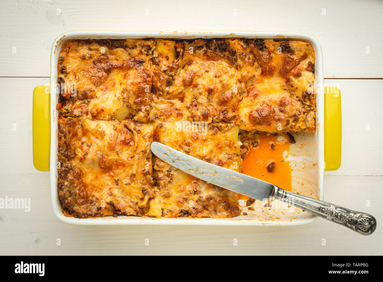 Italian Lasagna Bolognese with Beef, Cheese and Tomato Sauce on Rustic White Wooden Background Stock Photo