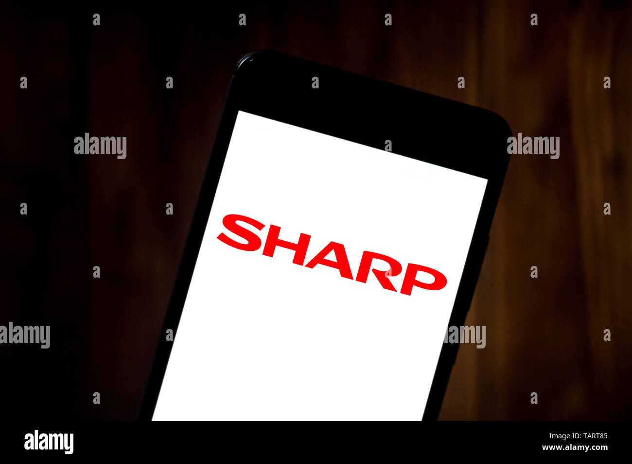 In this photo illustration the Sharp Corporation logo is seen displayed on a smartphone. Stock Photo
