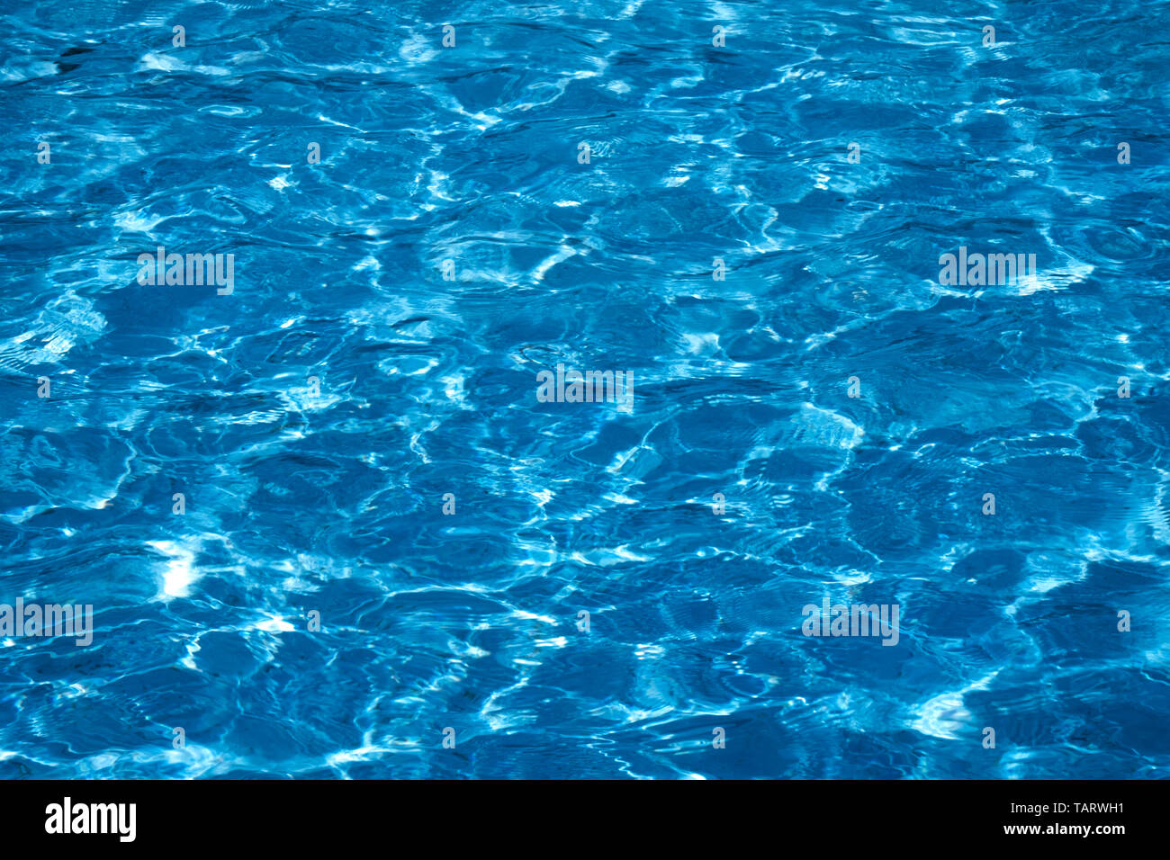 Blue and bright ripple clean water surface in swimming pool with sun ...