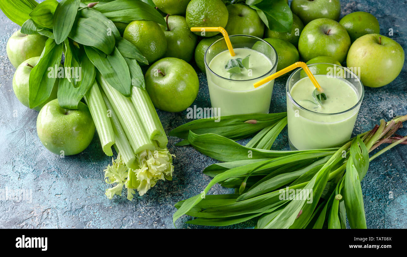 Food banner detox smoothie. Green apples, celery, ramson and limes on a concrete background