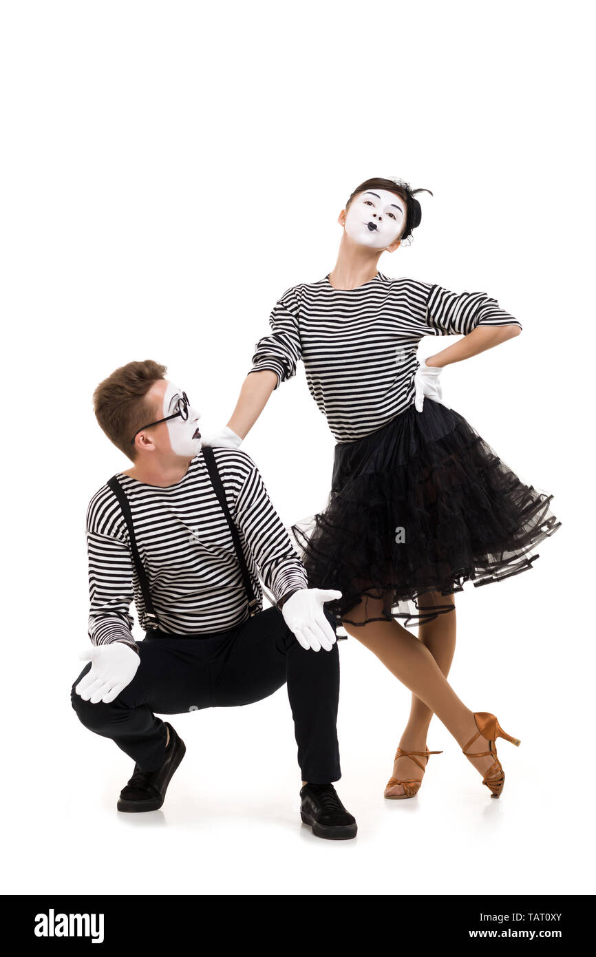 Smiling mimes in striped shirts. Man and woman dressed as actors of pantomime theater isolated on white background Stock Photo