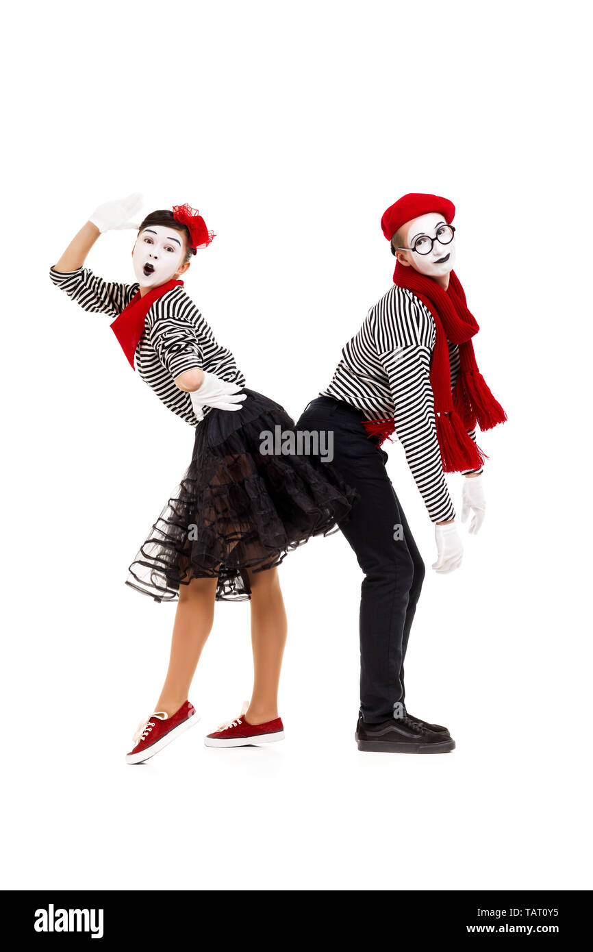 Smiling mimes in striped shirts. Man and woman dressed as actors of pantomime theater isolated on white background Stock Photo