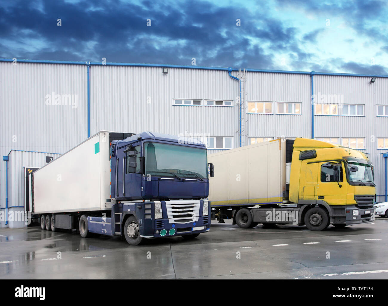 Unloading cargo truck at warehouse building Stock Photo