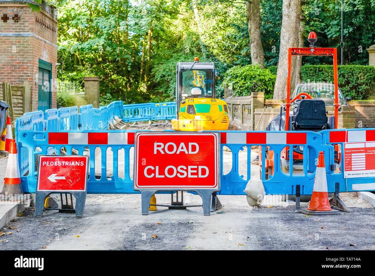 Street barricaded with ROAD CLOSED signs due to road maintenance Stock Photo