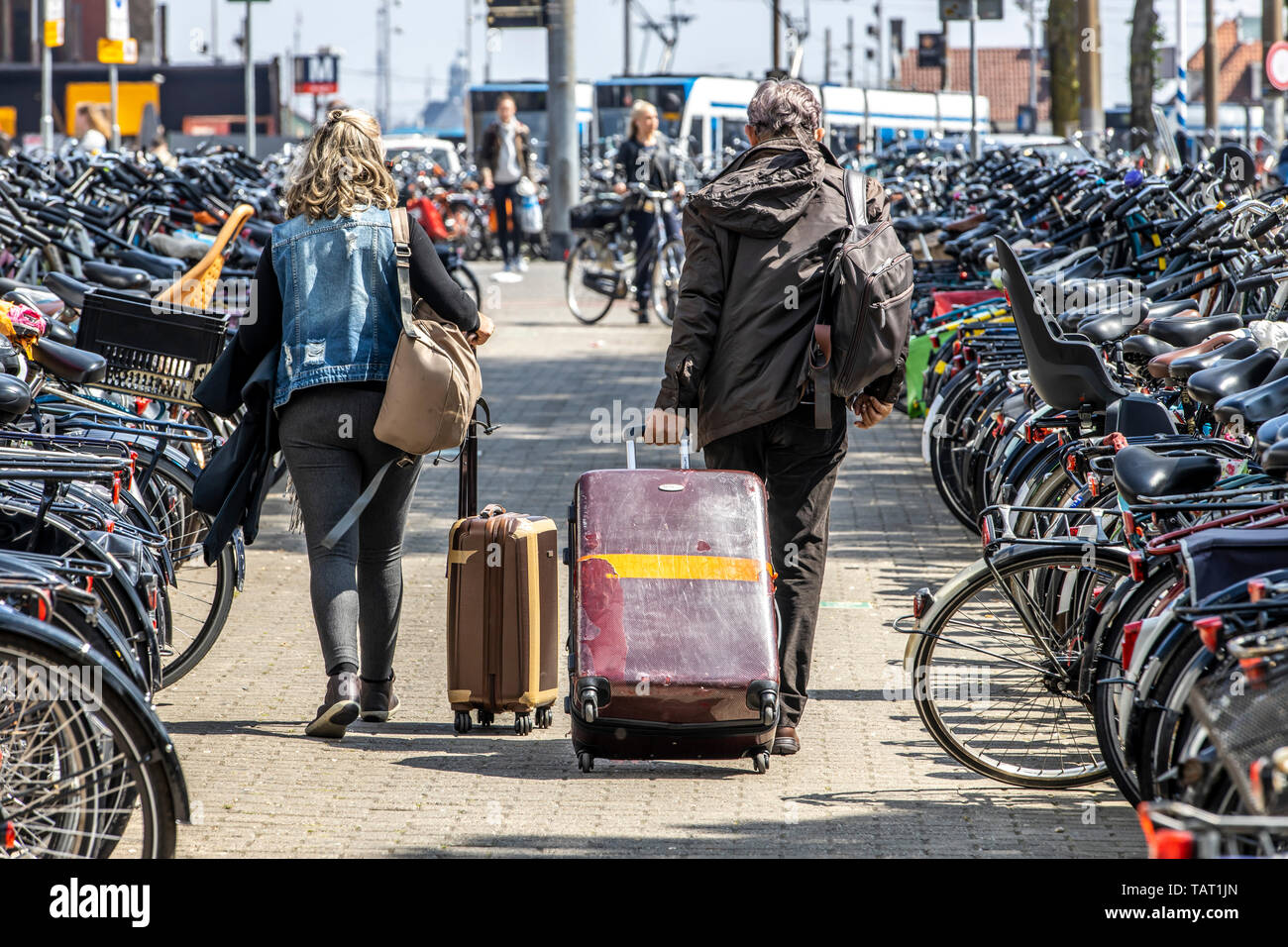 Tourists, visitors with trolleys, on the way, from, to the train station, Amsterdam Centraal, The Netherlands, Stock Photo