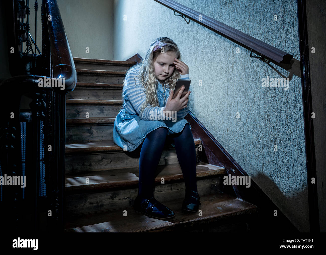 Sad depressed girl Bullied by text message humiliated online social media by classmates. Sad depressed young girl victim of cyberbullying by mobile ph Stock Photo