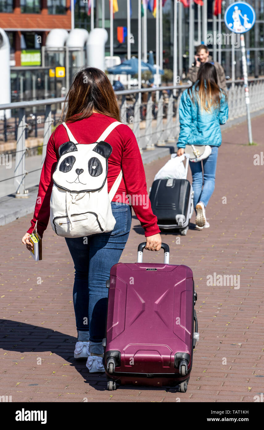 Tourists, visitors with trolleys, on the way, from, to the train station, Amsterdam Centraal, The Netherlands, Stock Photo