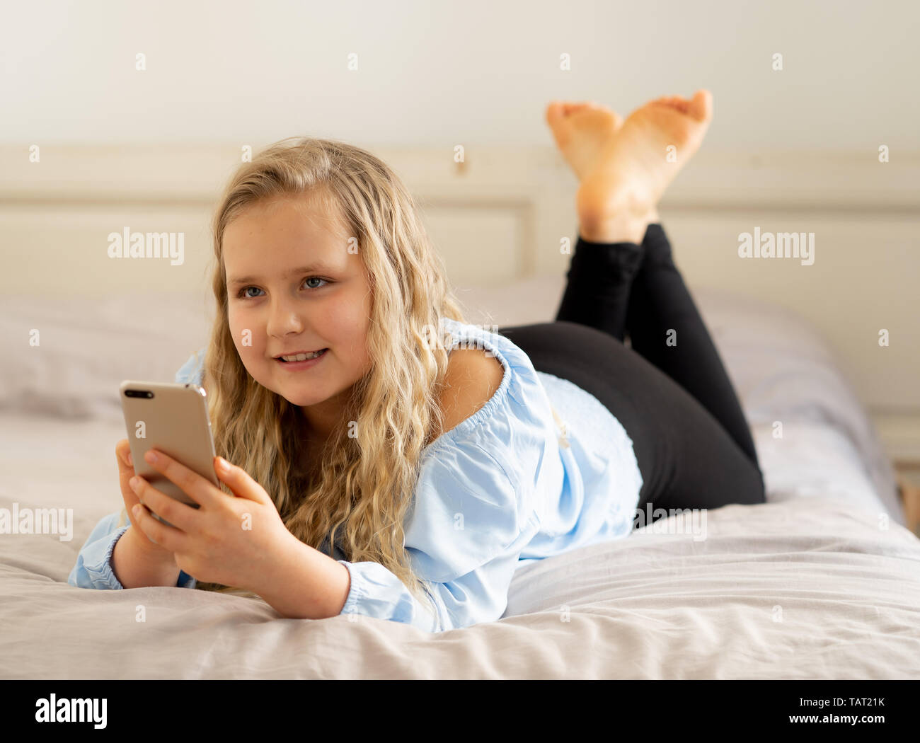 Beautiful Blonde Happy Little Girl Playing On Mobile Phone Cute