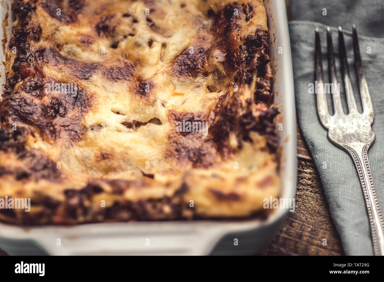 Rustic Italian Lasagna Bolognese on Dark Wooden Background Stock Photo